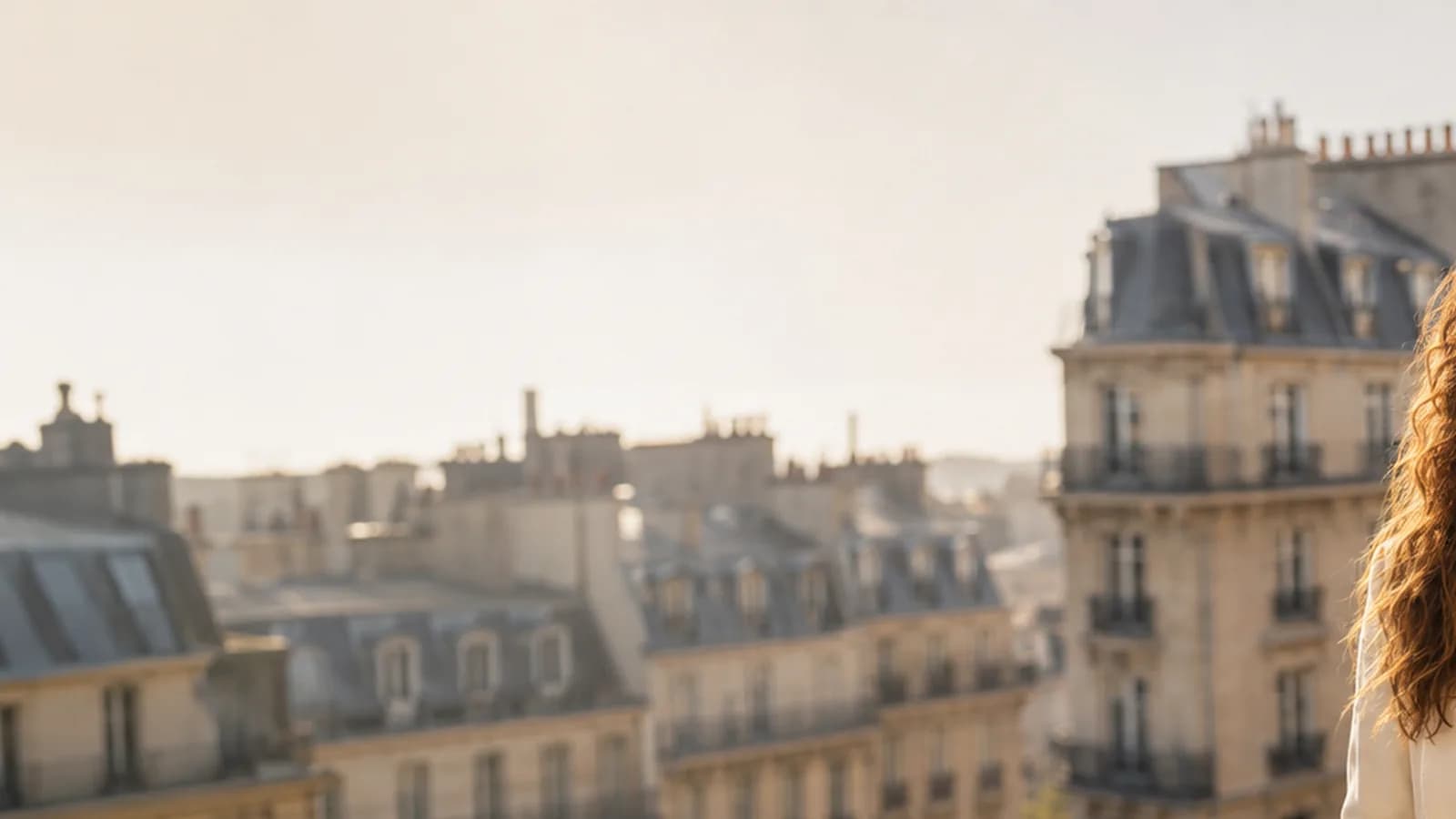 Warm Paris rooftops and classic architecture in golden light.
